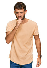 Fototapeta premium Handsome young man with beard wearing casual tshirt feeling unwell and coughing as symptom for cold or bronchitis. health care concept.