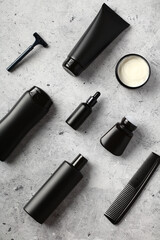 Obraz premium Set of men's cosmetics for skin care on stone desk table. Luxury black packaging design.