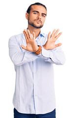 Young handsome man wearing business clothes rejection expression crossing arms doing negative sign, angry face