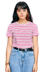Fototapeta premium Young hispanic girl wearing casual clothes relaxed with serious expression on face. simple and natural looking at the camera.