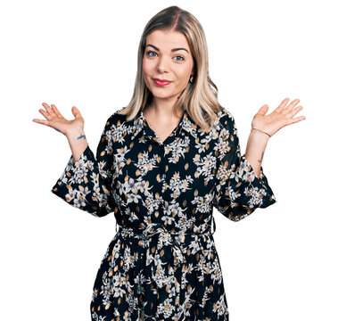 Young blonde woman wearing summer dress clueless and confused with open arms, no idea and doubtful face.