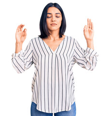 Young beautiful latin woman wearing casual clothes relax and smiling with eyes closed doing meditation gesture with fingers. yoga concept.