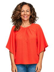 Middle age hispanic woman wearing casual clothes looking positive and happy standing and smiling...