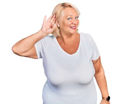 Middle age blonde woman wearing casual white t shirt smiling with hand over ear listening an hearing to rumor or gossip. deafness concept.