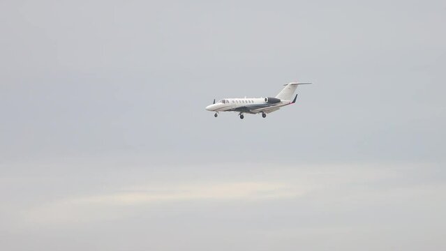 Generic Private VIP Business Executive Jet Flying Above the Clouds and Mountains during Decent