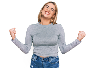 Young caucasian woman wearing casual clothes very happy and excited doing winner gesture with arms raised, smiling and screaming for success. celebration concept.