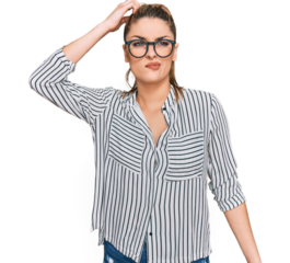 Young caucasian woman wearing business shirt and glasses confuse and wonder about question. uncertain with doubt, thinking with hand on head. pensive concept.