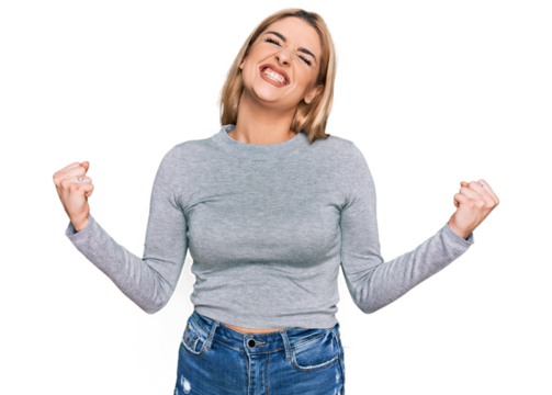 Young caucasian woman wearing casual clothes very happy and excited doing winner gesture with arms raised, smiling and screaming for success. celebration concept. - Powered by Adobe