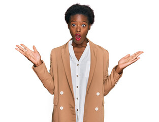 Young african american girl wearing business clothes celebrating victory with happy smile and winner expression with raised hands