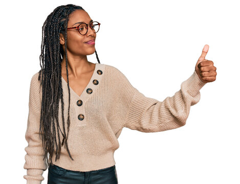 African american woman wearing casual clothes looking proud, smiling doing thumbs up gesture to the side