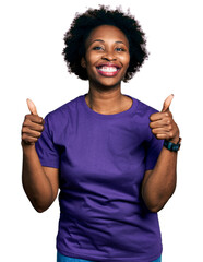 African american woman with afro hair wearing casual purple t shirt success sign doing positive...