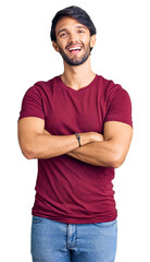 Fototapeta premium Handsome hispanic man wearing casual clothes happy face smiling with crossed arms looking at the camera. positive person.