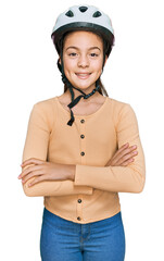 Beautiful brunette little girl wearing bike helmet happy face smiling with crossed arms looking at the camera. positive person.