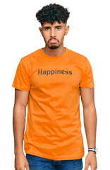 Young arab man wearing tshirt with happiness word message depressed and worry for distress, crying angry and afraid. sad expression.