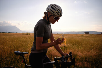 Cyclist holding a banana. Healthy nutrition of a cyclist. Healthy snack for a cyclist during...