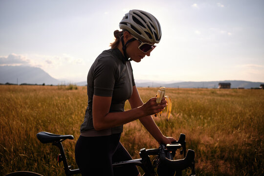Cyclist holding a banana. Healthy nutrition of a cyclist. Healthy snack for a cyclist during training.