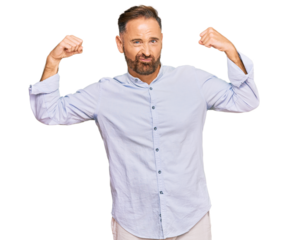 Handsome middle age man wearing business shirt showing arms muscles smiling proud. fitness concept.