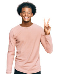 African american man with afro hair wearing casual clothes showing and pointing up with fingers number two while smiling confident and happy.