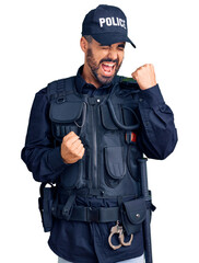 Young hispanic man wearing police uniform celebrating surprised and amazed for success with arms raised and eyes closed. winner concept.