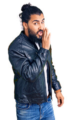 Young arab man wearing casual leather jacket hand on mouth telling secret rumor, whispering...