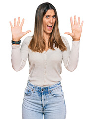 Young woman wearing casual clothes afraid and terrified with fear expression stop gesture with hands, shouting in shock. panic concept.