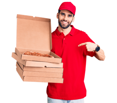 Young handsome man with beard wearing delivery uniform holding boxes with pizza pointing finger to one self smiling happy and proud