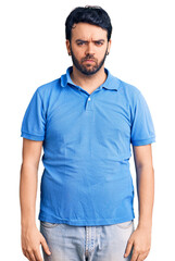Fototapeta premium Young hispanic man wearing casual clothes skeptic and nervous, frowning upset because of problem. negative person.