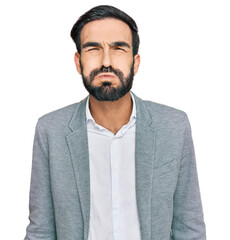 Young hispanic man wearing business clothes puffing cheeks with funny face. mouth inflated with air, crazy expression. - obrazy, fototapety, plakaty
