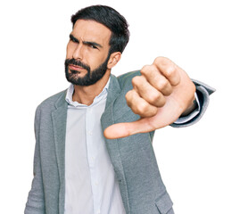 Young hispanic man wearing business clothes looking unhappy and angry showing rejection and negative with thumbs down gesture. bad expression.