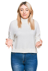 Obraz premium Young caucasian woman wearing casual winter sweater relaxed and smiling with eyes closed doing meditation gesture with fingers. yoga concept.
