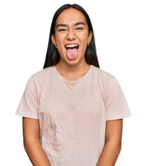 Young asian woman wearing casual clothes sticking tongue out happy with funny expression. emotion concept.