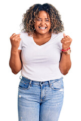 Young african american plus size woman wearing casual clothes celebrating surprised and amazed for success with arms raised and open eyes. winner concept.