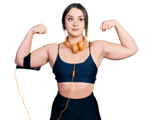 Young hispanic girl wearing sportswear doing strong gesture smiling looking to the side and staring away thinking.