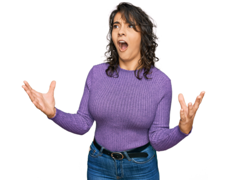 Young hispanic woman wearing casual clothes crazy and mad shouting and yelling with aggressive expression and arms raised. frustration concept.