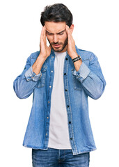 Young hispanic man wearing casual clothes with hand on head, headache because stress. suffering migraine.