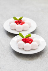 Red currant truffle. Red currant cream dessert on a plate.Light gray background. Close up	
