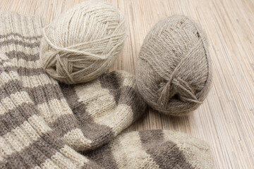 Fototapeta na wymiar Cozy knitted socks and skeins.