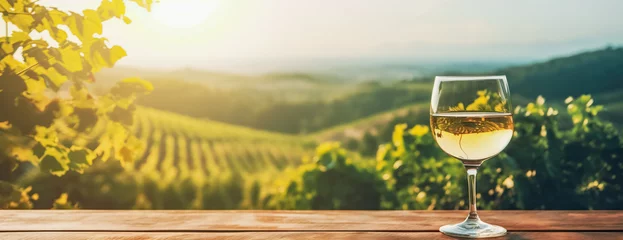 Tuinposter Empty wood table top with a glass of wine on blurred vineyard landscape background, for display or montage your products. Agriculture winery and wine tasting concept, digital ai © Viks_jin