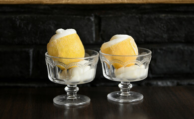 Ice cream sorbet in lemon and glass on dark background - obrazy, fototapety, plakaty