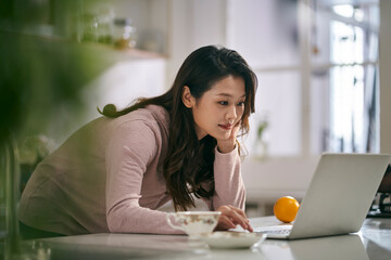 young asian woman female freelancer working at home