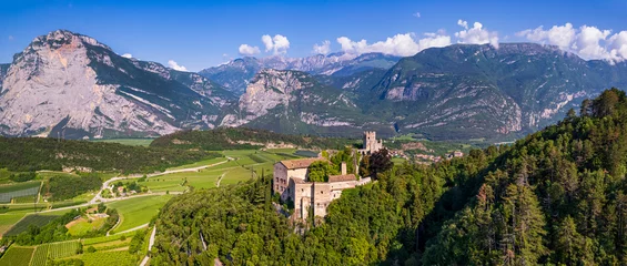 Poster Italy travel destinations. Famous medieval castle Madruzzo in Trentino Alto Adige region province of Trento. Aerial panoramic drone view © Freesurf
