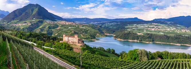 most famous and beautiful medieval castles of northern Italy. Cles - in Trentino , province of Trento. surrouded by fields of apple trees near the lake Santa Giustina - obrazy, fototapety, plakaty
