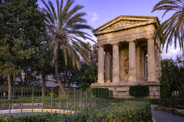 Monument to Alexander Ball with palm trees and a beautiful fountain in the Valletta Garden in Malta.