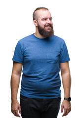 Obraz premium Young caucasian hipster man over isolated background looking away to side with smile on face, natural expression. Laughing confident.
