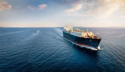 A big LNG tanker ship travelling over the calm ocean during sunset as a concept for international...