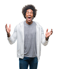 Afro american man wearing sweatshirt over isolated background celebrating mad and crazy for success with arms raised and closed eyes screaming excited. Winner concept - obrazy, fototapety, plakaty