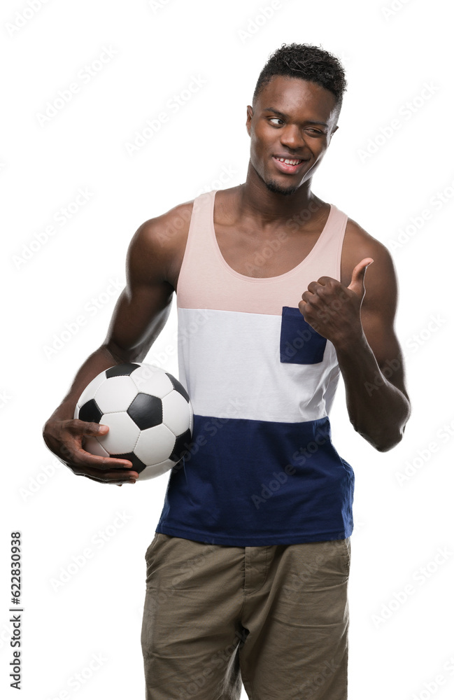 Sticker young african american man holding soccer football ball pointing with hand and finger up with happy 