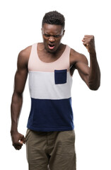 Naklejka premium Young african american man annoyed and frustrated shouting with anger, crazy and yelling with raised hand, anger concept