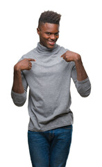 Young african american man over isolated background looking confident with smile on face, pointing oneself with fingers proud and happy.