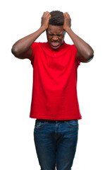 Fototapeta premium Young african american man over isolated background suffering from headache desperate and stressed because pain and migraine. Hands on head.